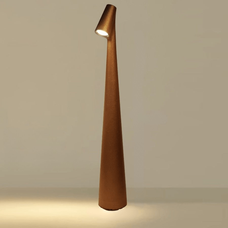 Red cordless table lamp in another view with a slim tapered shape and angled head.