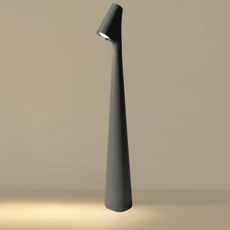 Red cordless table lamp in another view with a slim tapered shape and rounded angled head.