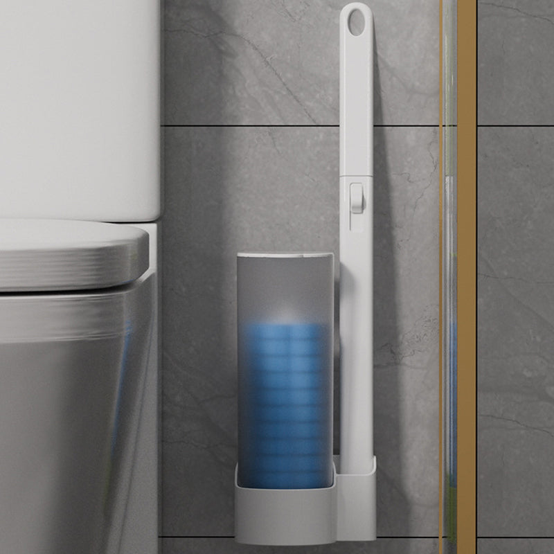 Disposable Toilet Brush with a wall-mounted holder and blue sponge heads beside a toilet.