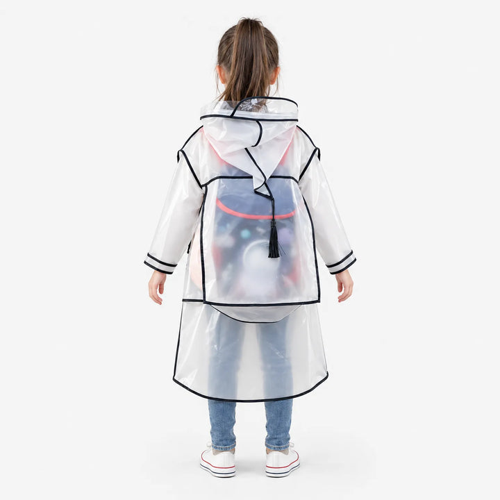 Back view of a girl in the black-trimmed raincoat, showing the extended backpack panel with a tassel pull covering her school bag. 4