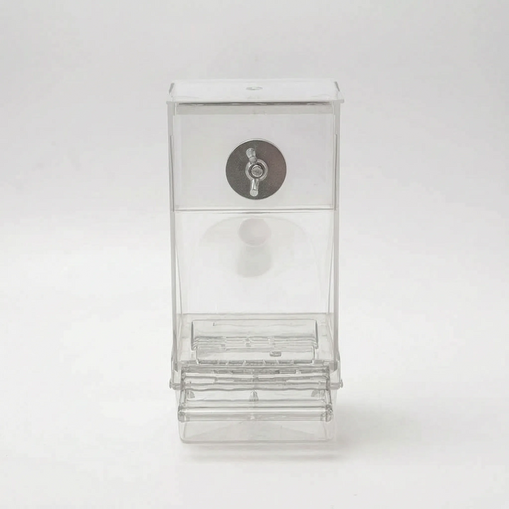 Front view of the empty clear feeder on a plain background, showing the metal fastening disc and the open feeding tray. 5
