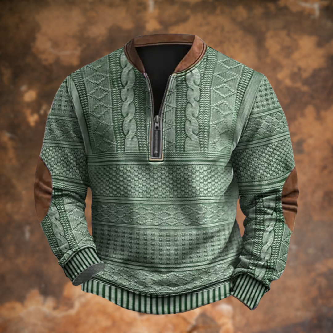 Front view in sage green with cable and diamond knit pattern, metal quarter zipper, brown collar and elbow patches. 6