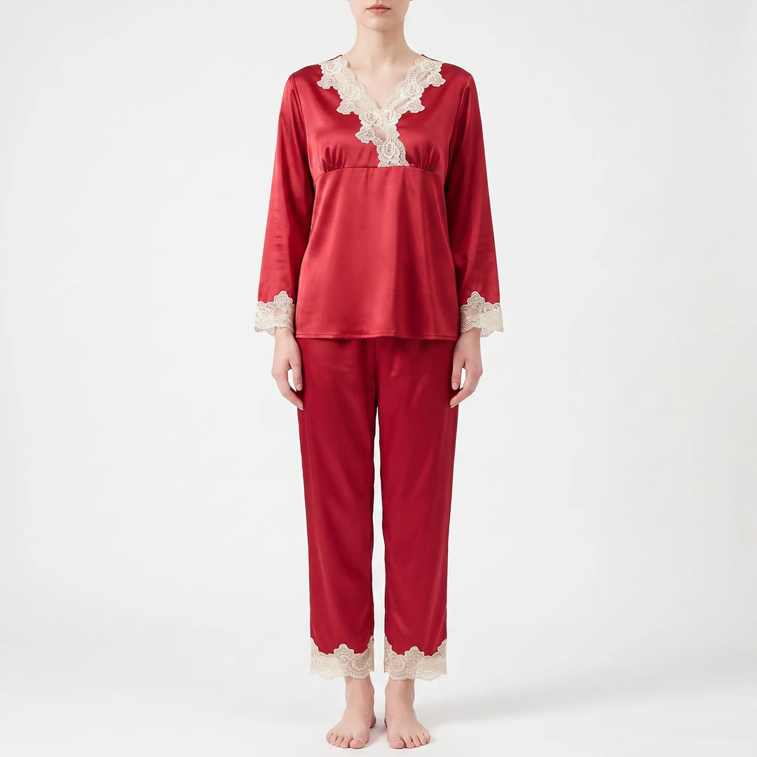 Full front view of a model standing barefoot in the red satin pajama set with cream lace trim. 6