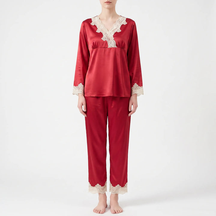 Full front view of a model standing barefoot in the red satin pajama set with cream lace trim. 6