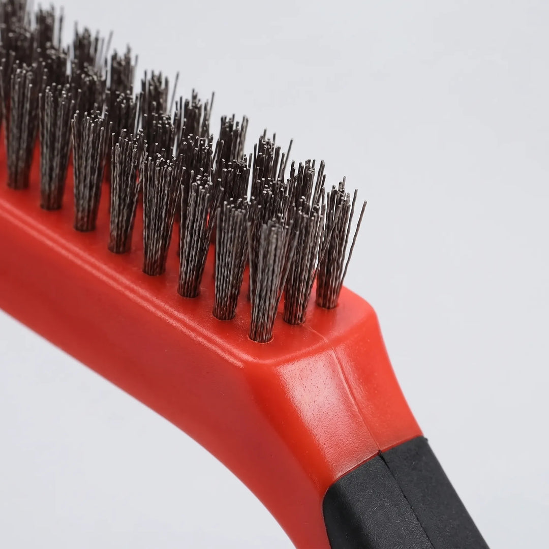 Close-up of the red wire brush head, showing dense steel bristles in rows and the black handle grip. 3