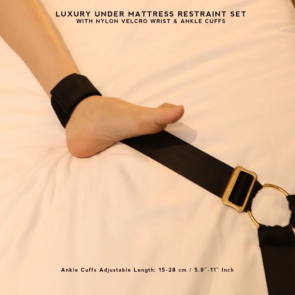Under-Bed Restraint Set with Adjustable Cuffs detail of a black ankle cuff with gold buckle