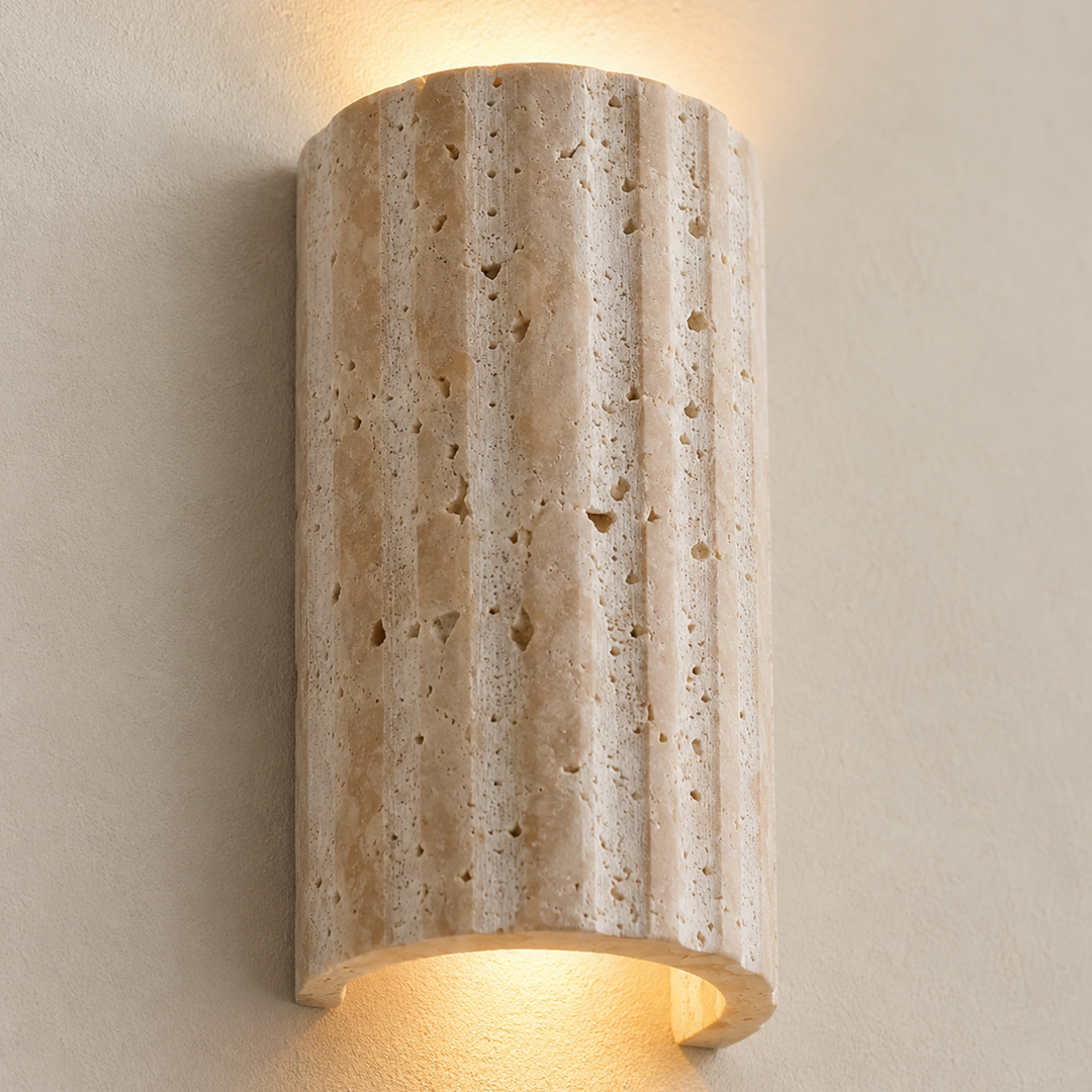 Natural Stone Wall Sconce Wall Light close-up of the porous vertically ribbed stone surface and curved edge.