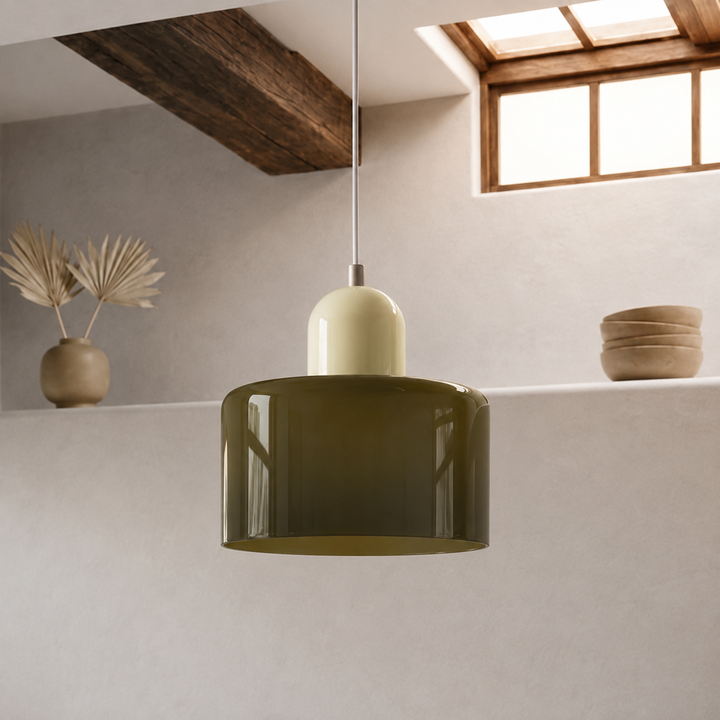 Pendant lamp with a glossy olive-green glass drum shade and cream dome cap, hanging in a rustic room with a wooden beam. 41