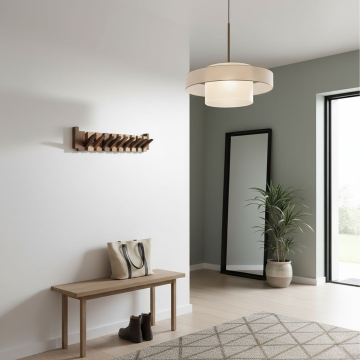 Dark wood wall-mounted hook rack in a bright entryway above a wooden bench, with a tote bag, boots, mirror and plant. 1