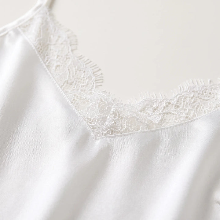 Close-up of the lace-trimmed V-neckline, showing the delicate white floral lace with eyelash edging against smooth, glossy satin. 5