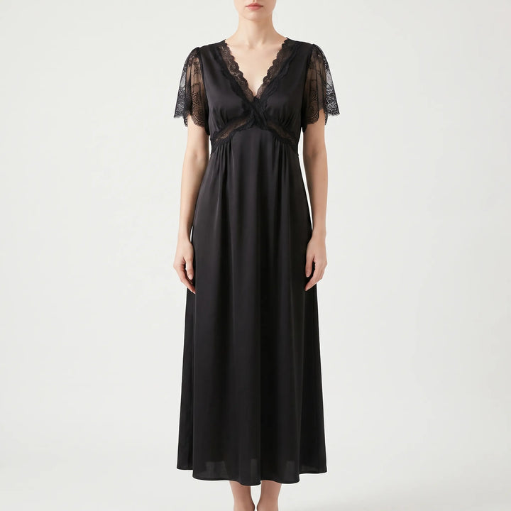 Front view of the nightgown in black satin on a model, with a lace V-neck, lace waist band and sheer lace sleeves. 6