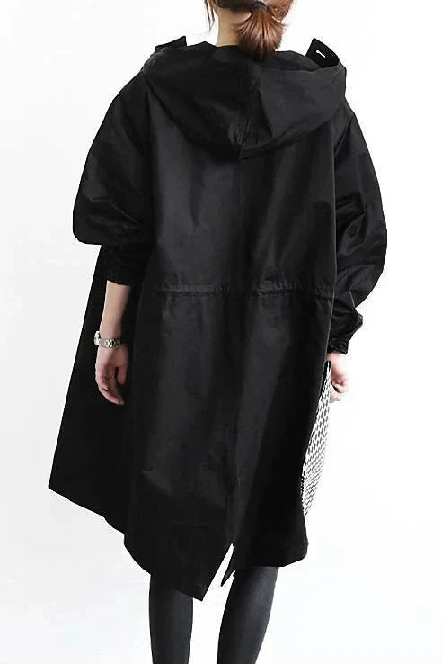 Black waterproof hooded trench coat back view showing the drawstring waist and hem