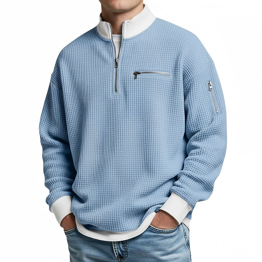 Front view of a light blue waffle knit quarter-zip sweater with a white collar and cuffs.