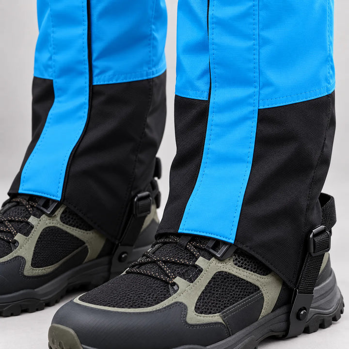 Close-up of bright blue and black gaiters over black and gray hiking shoes, showing the side zipper, stitching and instep strap buckle. 5