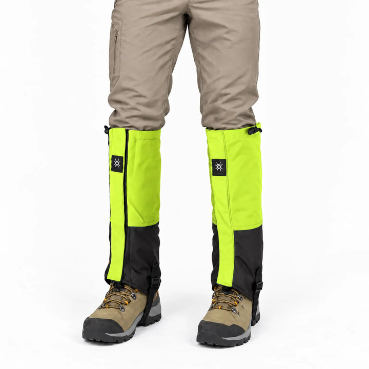 Front view of lime green and black gaiters worn over tan pants and brown hiking boots on a white background. 6