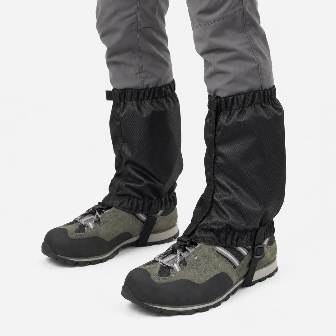 Black ripstop gaiters on a model's lower legs, seen from a side angle, with elastic top and bottom and a boot strap. 5