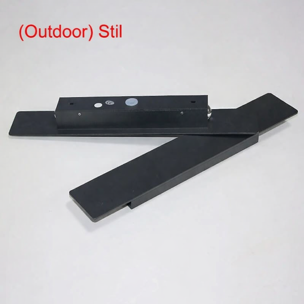Black light body with mounting plate and separate rectangular cover plate laid on a light gray surface, showing the parts before assembly. 5