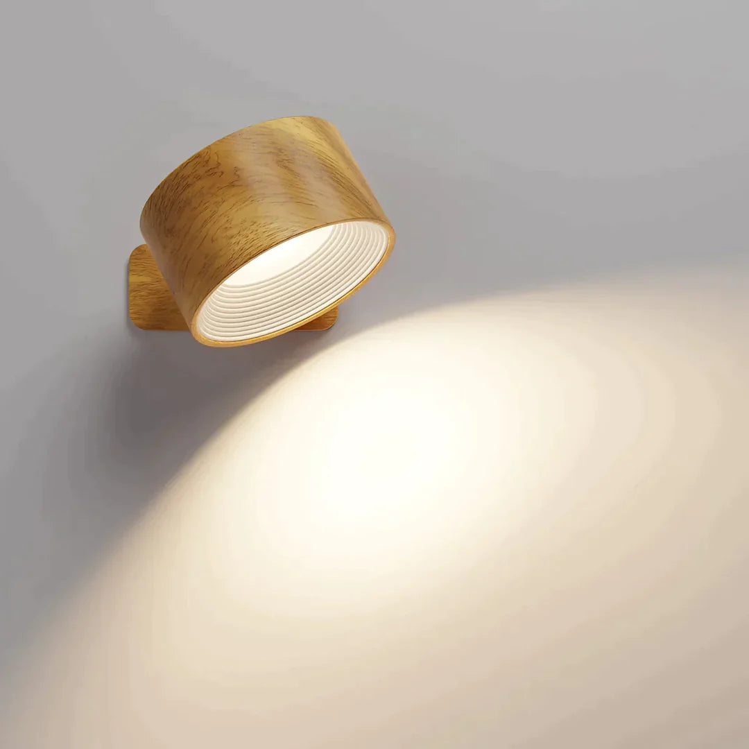 Wood-grain cordless LED wall light with a white ridged interior, tilted to spill warm light down the wall.