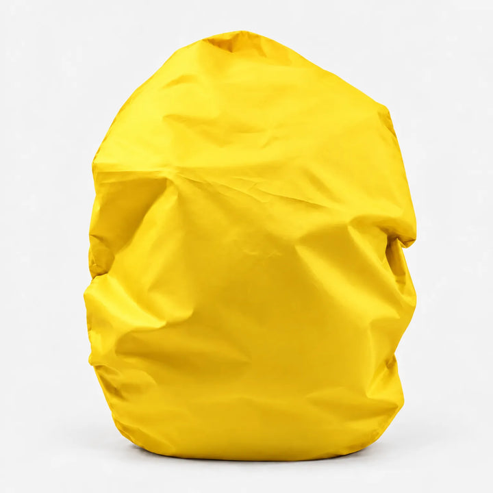 Yellow backpack cover shown alone on a white background, front view with soft creases in the fabric. 12