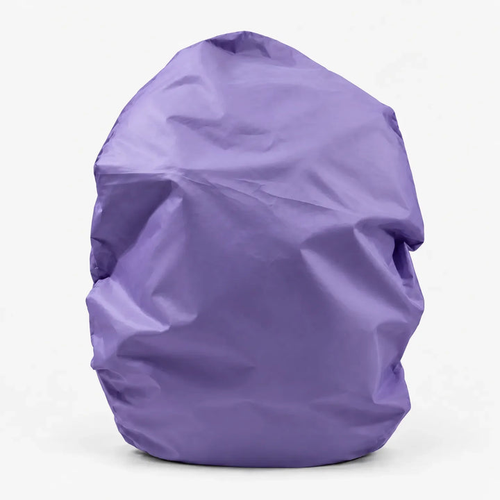 Lavender purple backpack cover shown alone on a white background, front view with soft creases in the fabric. 14