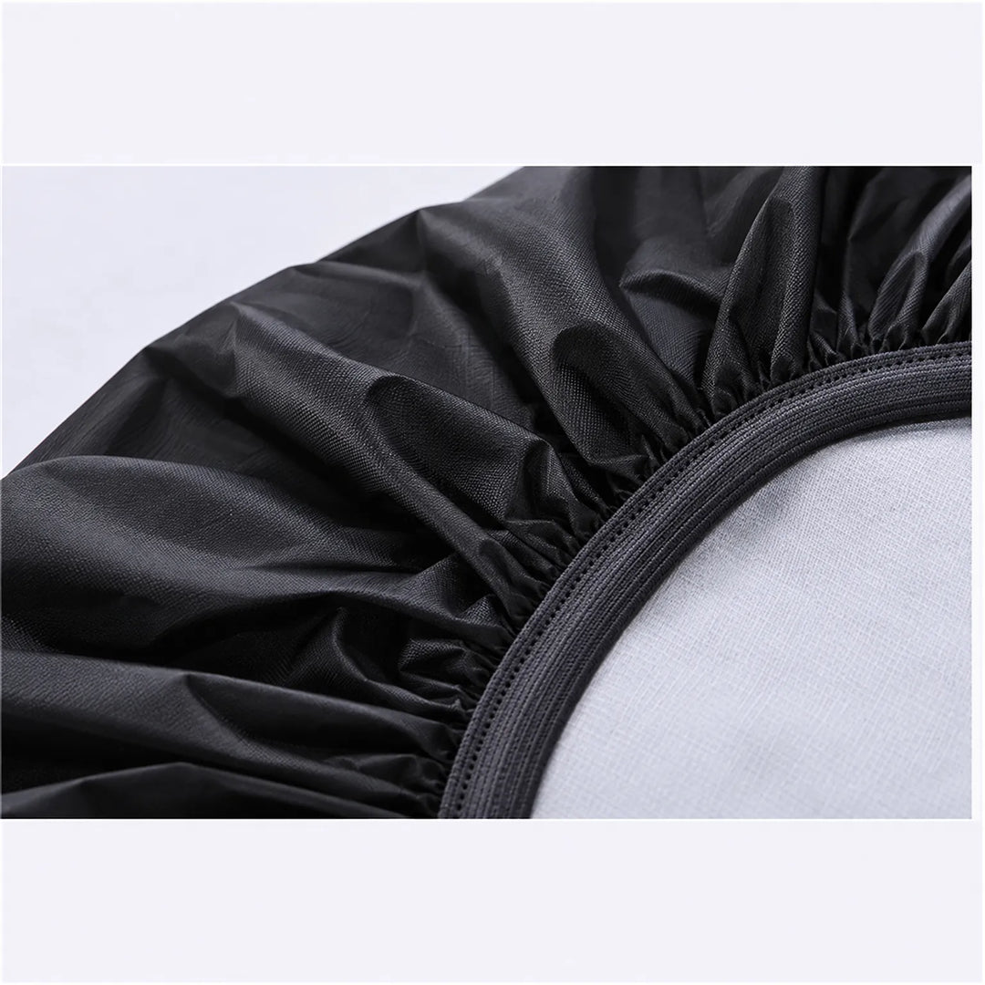 Close-up of the cover's elasticated hem in black, showing the gathered fabric and the stitched elastic band along the opening. 6
