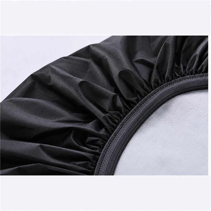 Close-up of the cover's elasticated hem in black, showing the gathered fabric and the stitched elastic band along the opening. 6