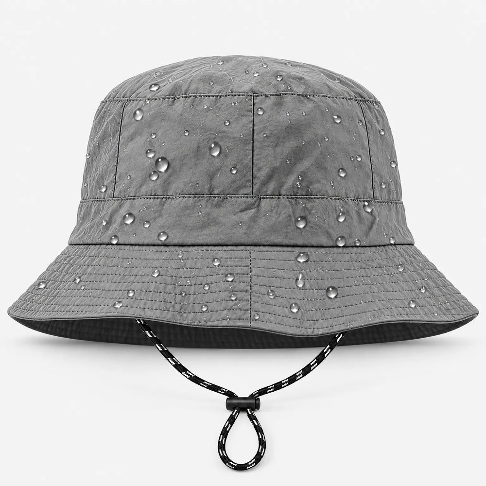 Front view of a gray bucket hat covered in water droplets, with a black-and-white drawcord and toggle hanging below the brim. 2