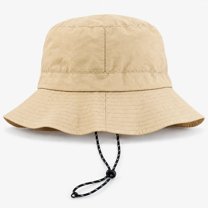 Back view of a beige bucket hat with a seam down the center and a black-and-white drawcord hanging below the brim. 7