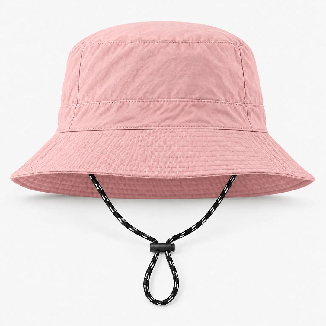 Front view of a light pink bucket hat with a subtle grid texture and a black-and-white drawcord with a black toggle. 8