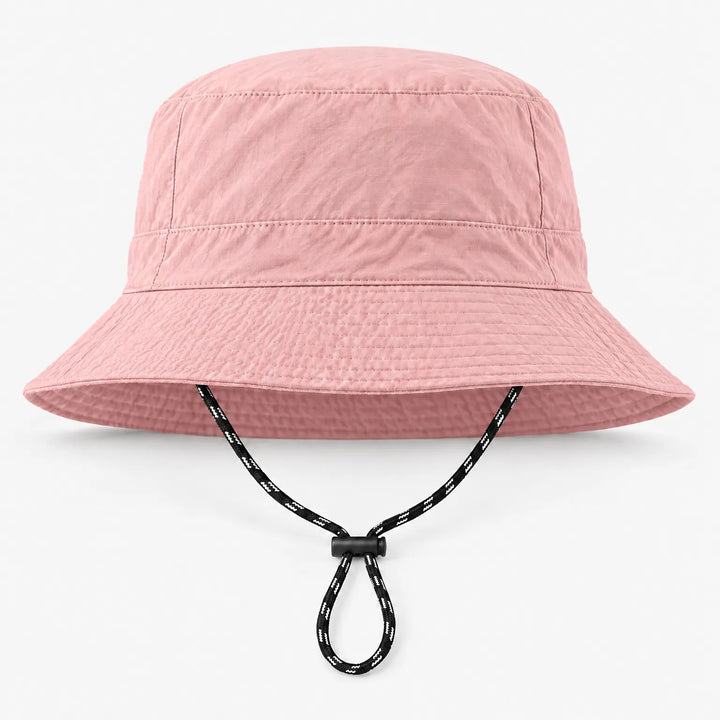 Front view of a light pink bucket hat with a subtle grid texture and a black-and-white drawcord with a black toggle. 8