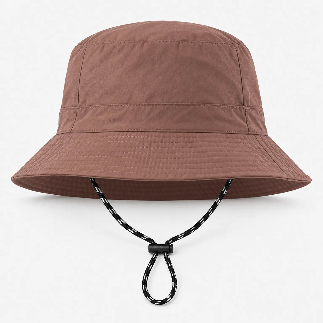 Front view of a brown bucket hat with a smooth finish, stitched brim and a black-and-white chin cord with toggle. 9