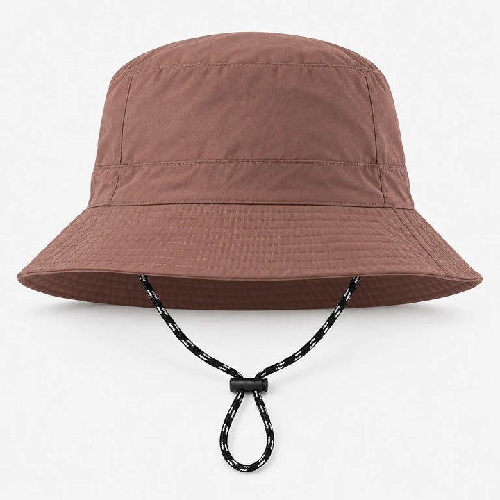 Front view of a brown bucket hat with a smooth finish, stitched brim and a black-and-white chin cord with toggle. 9