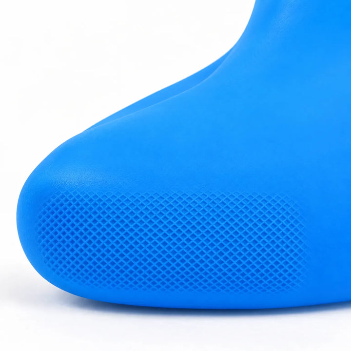Close-up of a blue shoe cover's toe, showing the fine crosshatch grip texture on the sole. 6