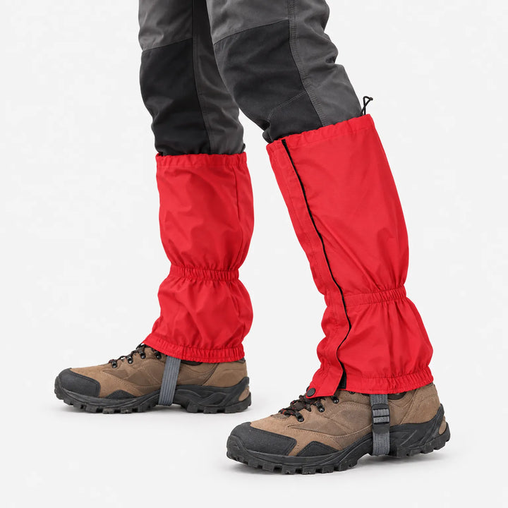 Close view of red gaiters worn over brown hiking boots, showing the side zipper, elastic ankle gather and under-boot strap. 5