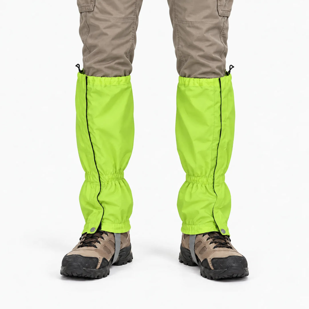 Front view of a lime green gaiter pair worn with khaki pants and hiking boots, showing side zips and snap closures. 7