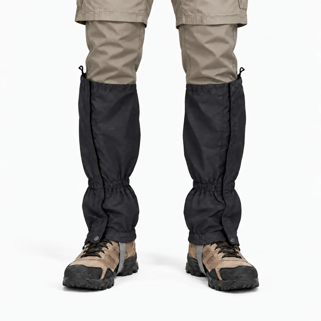 Front view of a black gaiter pair worn with khaki pants and hiking boots, showing side closures and elastic ankle cuffs. 9