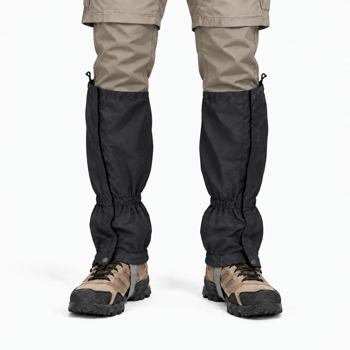 Front view of a black gaiter pair worn with khaki pants and hiking boots, showing side closures and elastic ankle cuffs. 9