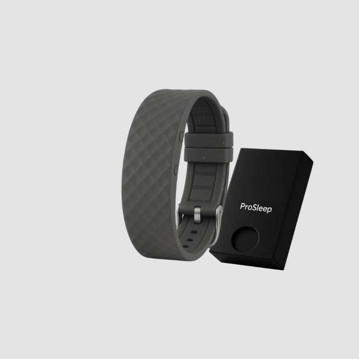Dark gray silicone vibration alarm clock detail with a metal buckle beside a small black gift box.