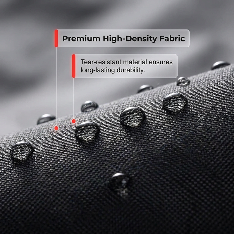 Close-up of tightly woven black fabric with water droplets beading on its surface.
