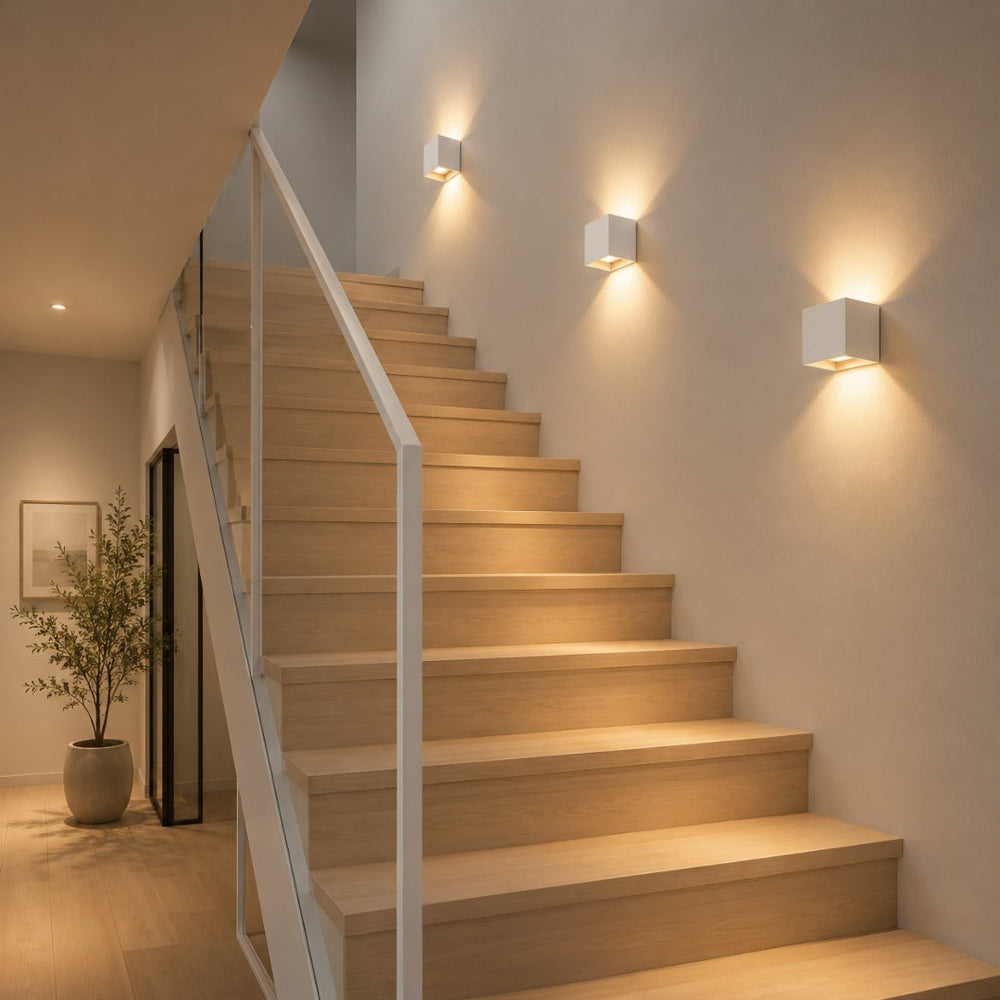 White square aluminium wall lamp with warm light, another view.