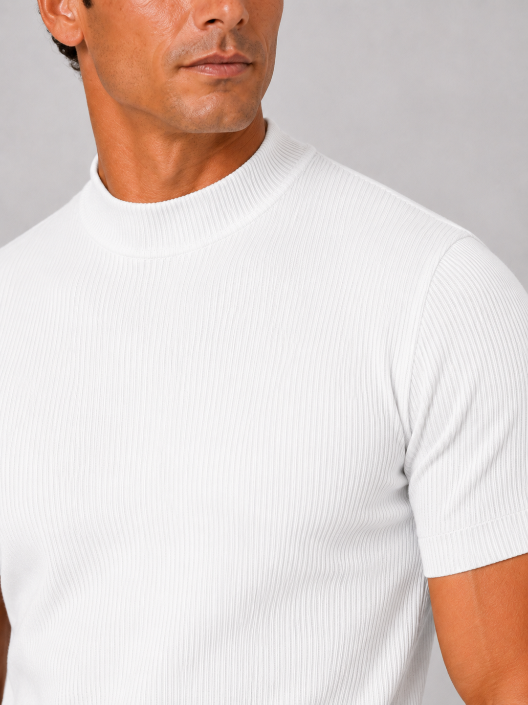 Close-up of the white ribbed knit texture, mock neck collar and short sleeve on a men's tee.