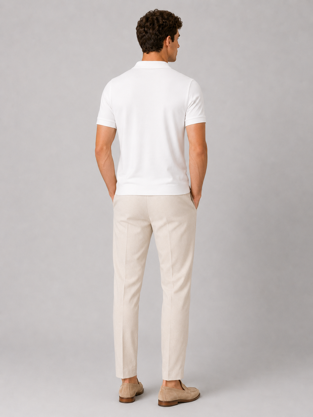 White silky touch polo shirt back view on a model.