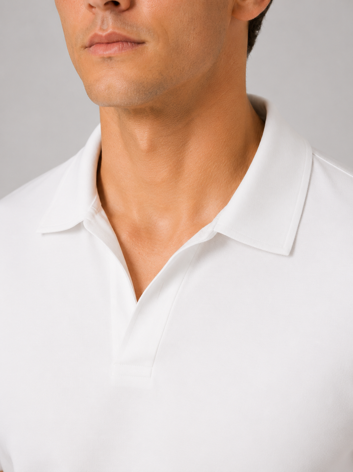 White silky touch polo shirt detail of the open V neckline and collar.