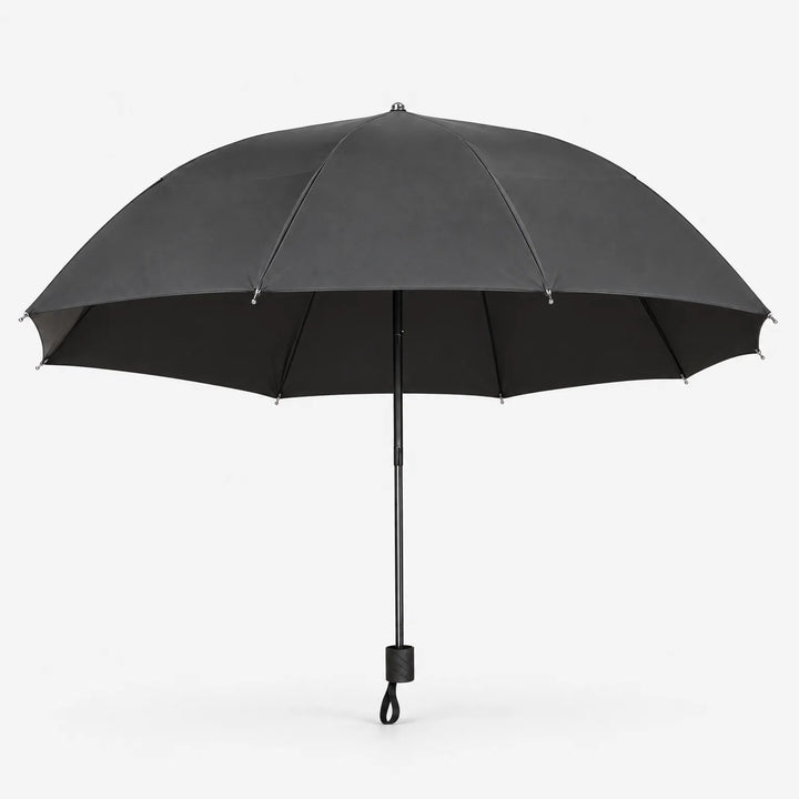 Open dark gray umbrella seen from the side on a white background, showing the black lining, metal-tipped ribs and handle with wrist loop. 3