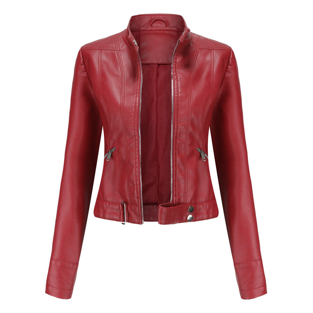 Front view of the red cropped jacket, unzipped, with stand collar, zippered pockets and a buckled waist band. 3