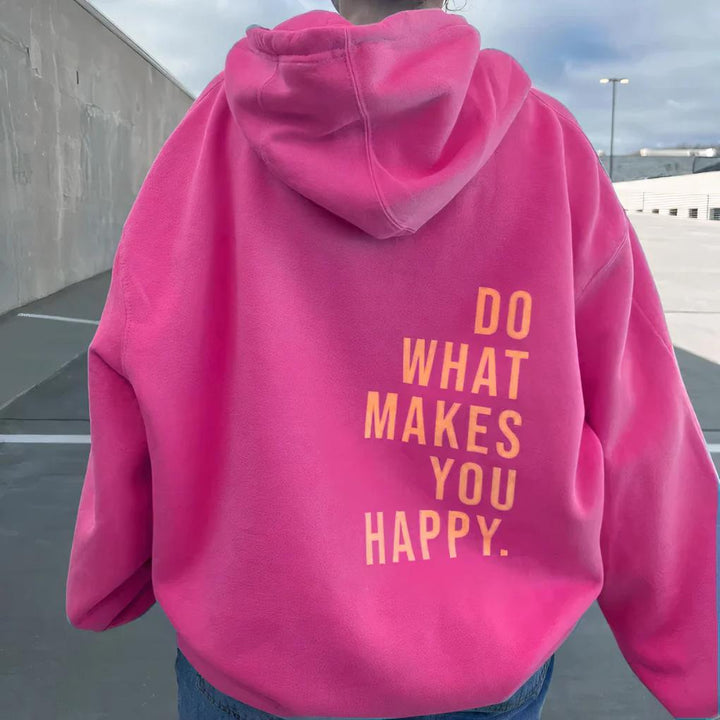 Women's Hoodie with Kangaroo Pocket and Thumb Holes in bright pink with an orange slogan on the lower back.