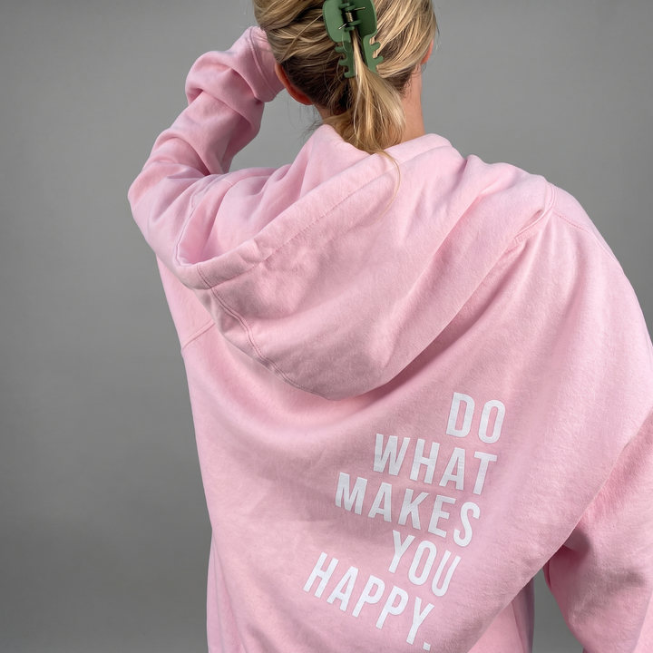 Women's Hoodie with Kangaroo Pocket and Thumb Holes in light pink with a large white slogan print on the back.