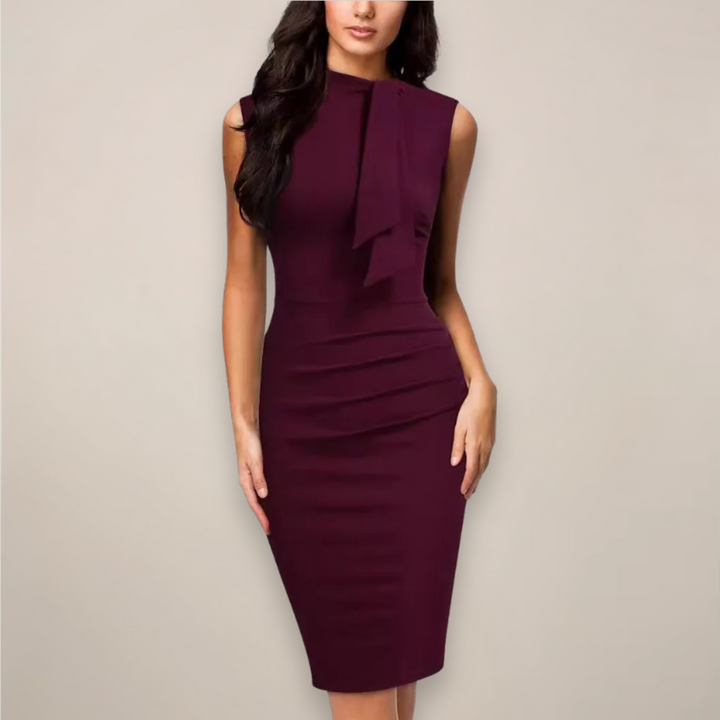 Front view of a model wearing the red sleeveless sheath dress with a draped neck tie and ruched side waist.