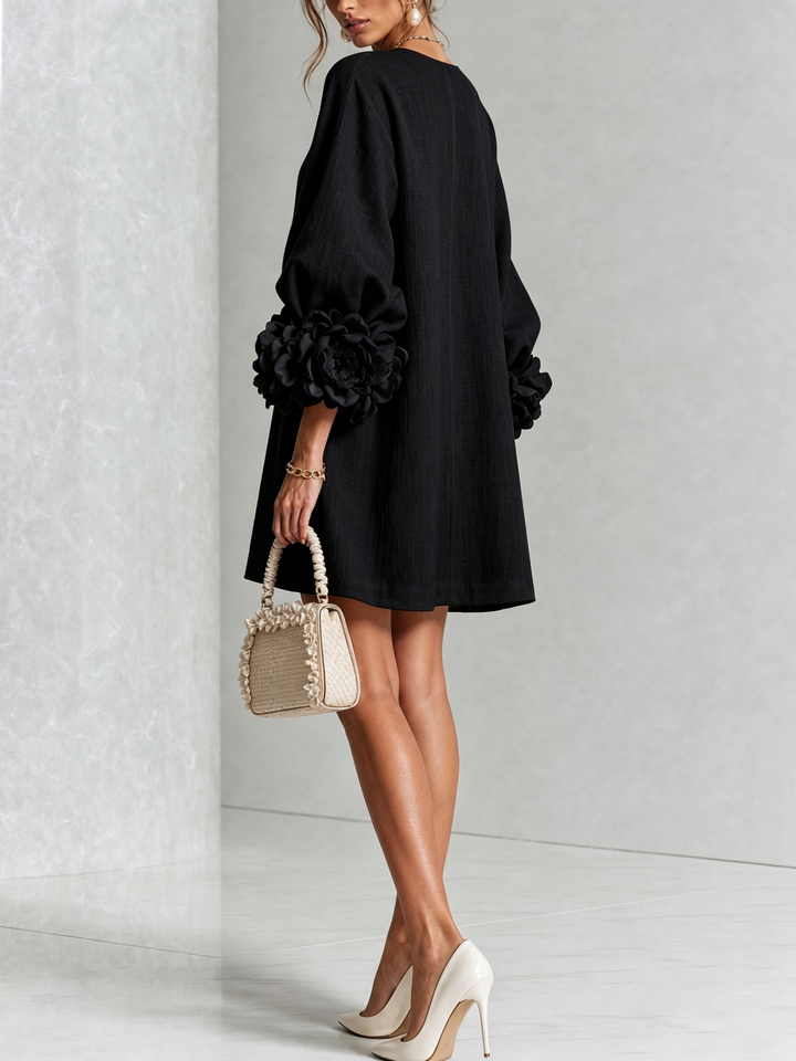 Back view of the black dress, showing the plain back and large rose cuffs 17