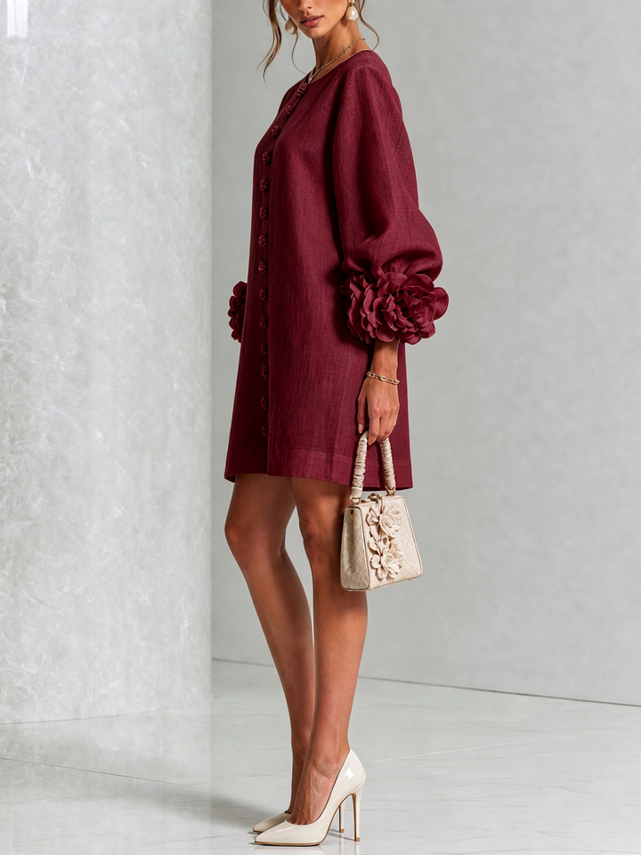 Side view of the burgundy dress with puff sleeves, rose cuffs and a cream handbag 36